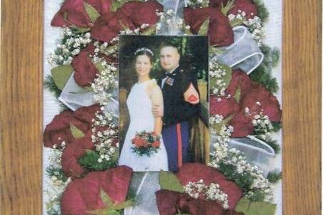 wedding photo surrounded by bouquet accented with the sheer ribbon from the bride's hair