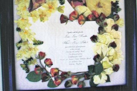 yellow, white and red roses artistically surrounding invite and envelope