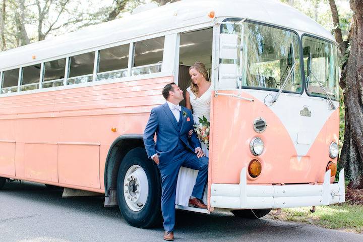 Newlyweds stepping out of the Vintage VW Bus