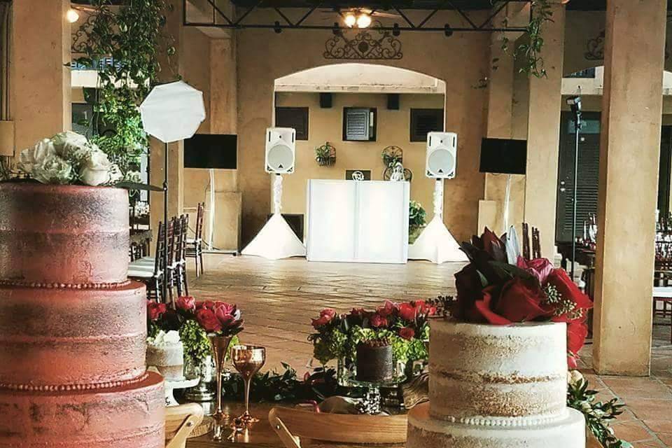 View of the DJ booth from wedding cake table