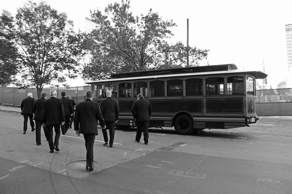 Groomsmen walking towards the trolley