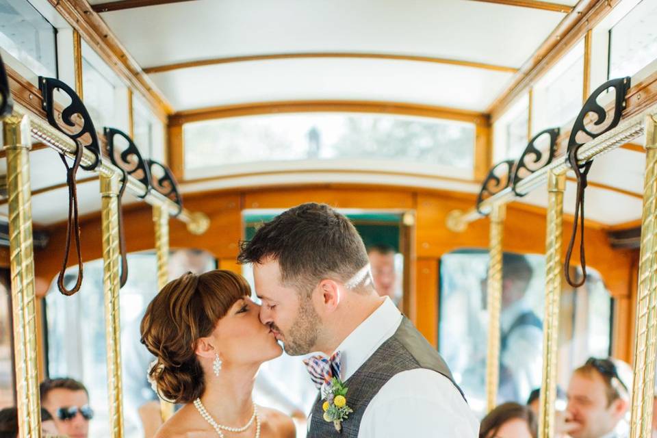 Newlyweds kissing in the trolley
