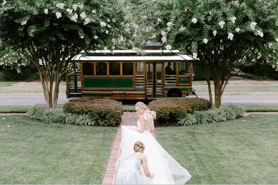 Bride being assisted to the trolley