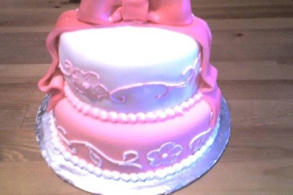 Pink and white fondant cake with hand drawn scroll work in butter cream. Cost: $150.