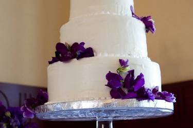 Cream cheese frosting covered a carrot cake, red velvet cake, and chocolate cake for this bride and groom's wedding.