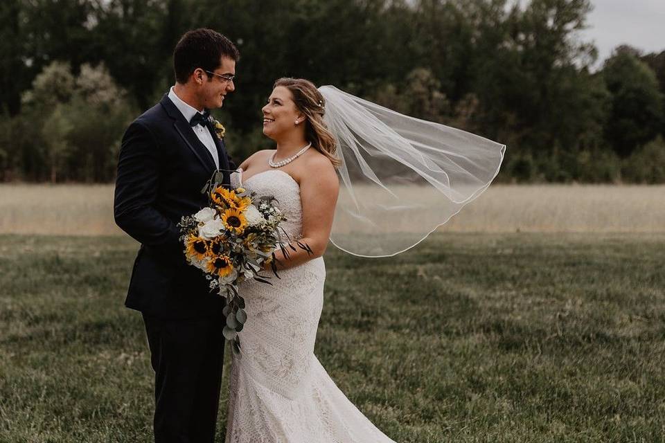 Bright and bold yellow sunflowers highlighted this classic white rose bridal bouquet. Photograph by Jessie Walker Photography