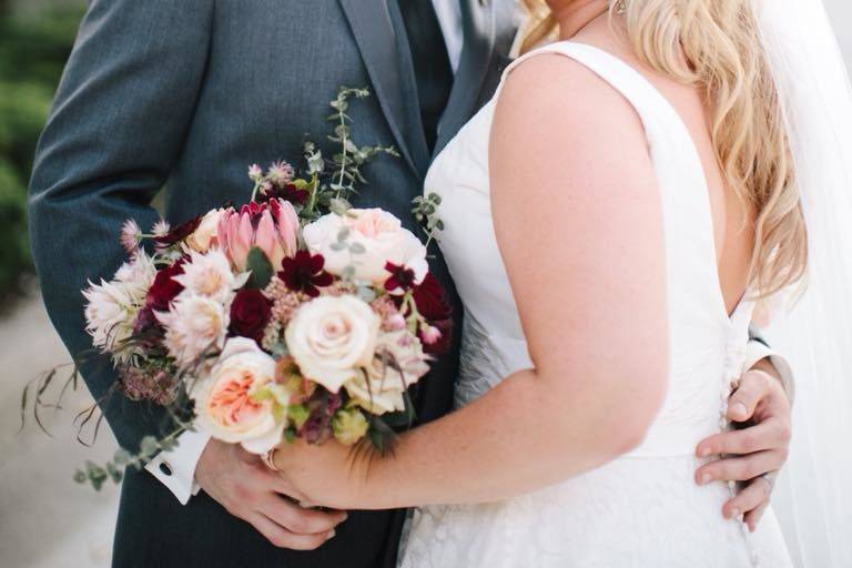 Groom holding his bride