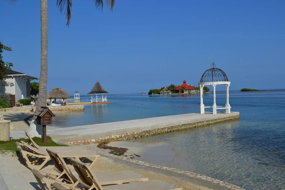 Beach area of Sandals Royal Caribbean with the Royal Thai restaurant and the private island in the background