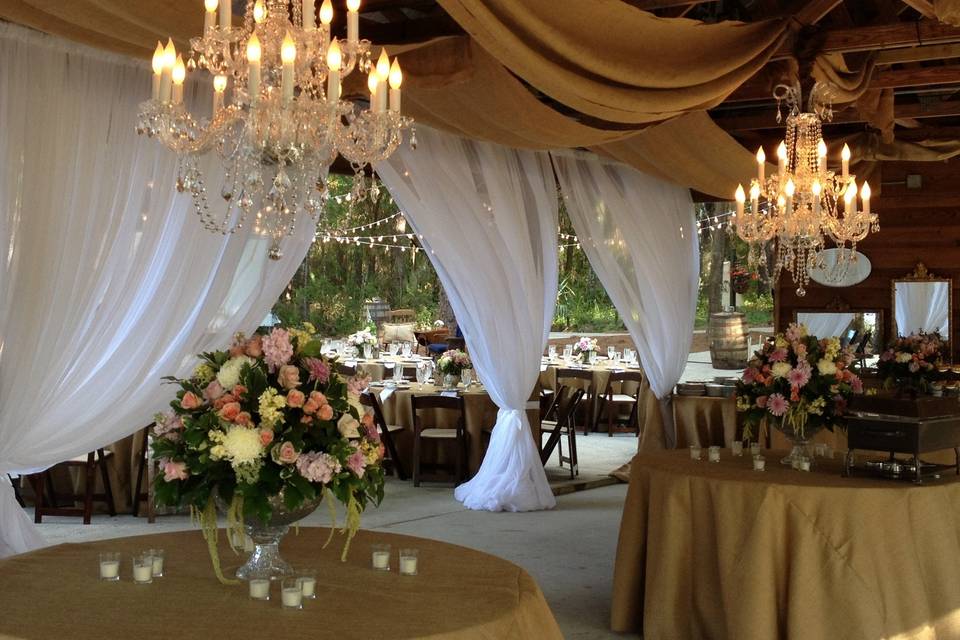 A combination of white sheers, burlap and crystal chandeliers.  It doesn't get any better than that!