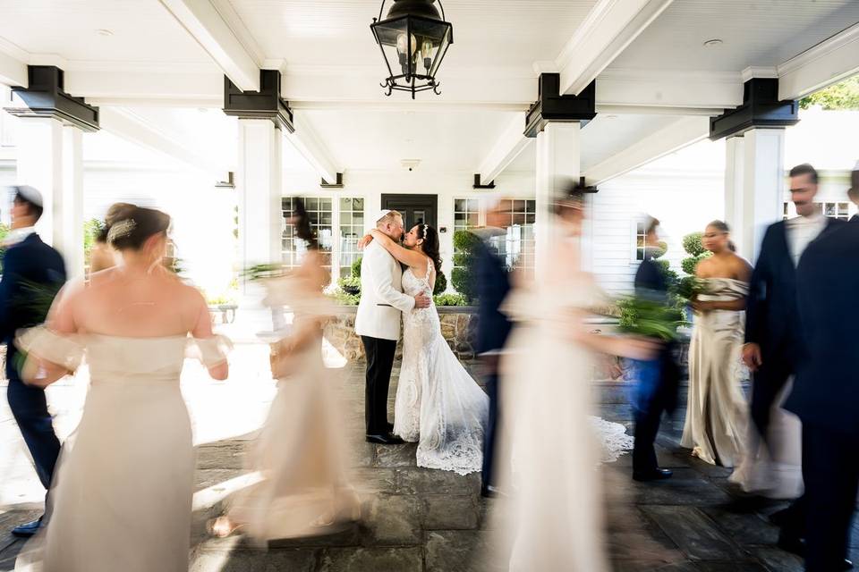 Couple Kissing bridal party in