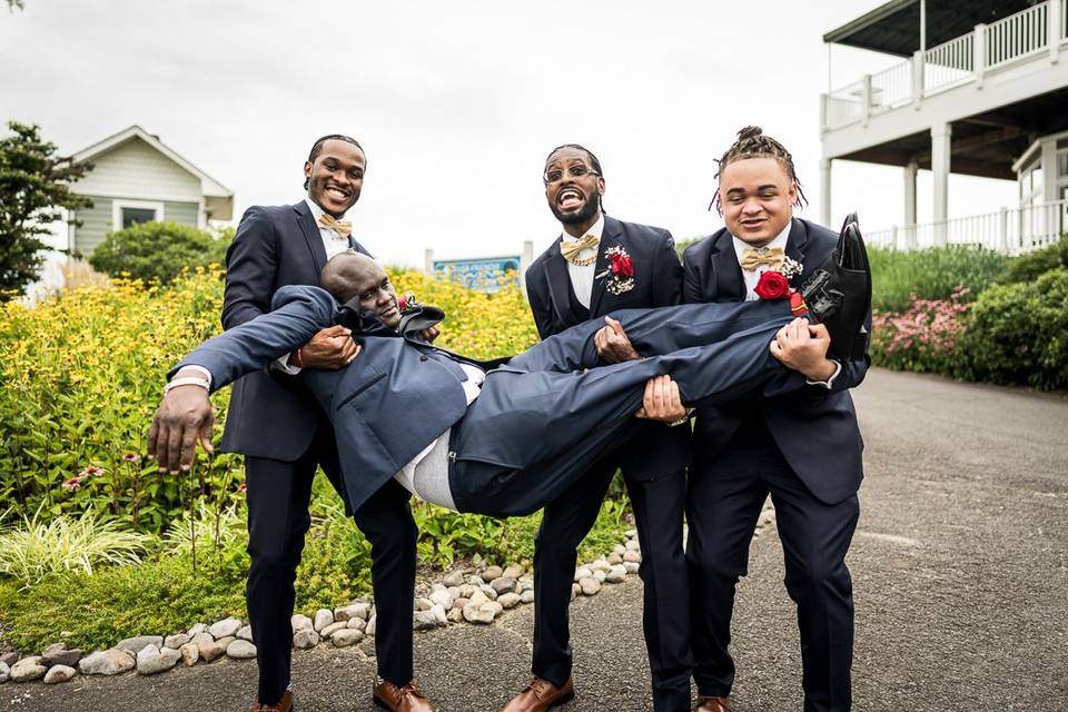 Groomsman holding up the groom