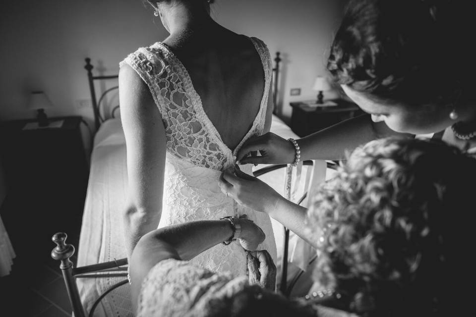 Assisting the bride with her gown