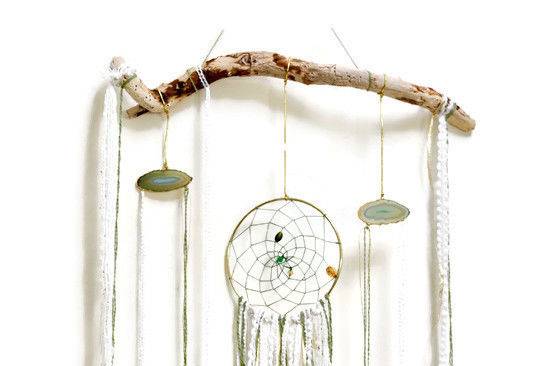 Sea foam green and gold dream catcher hanging on a piece of local drift wood. A simplebut beautifulpiece for one couple's wedding