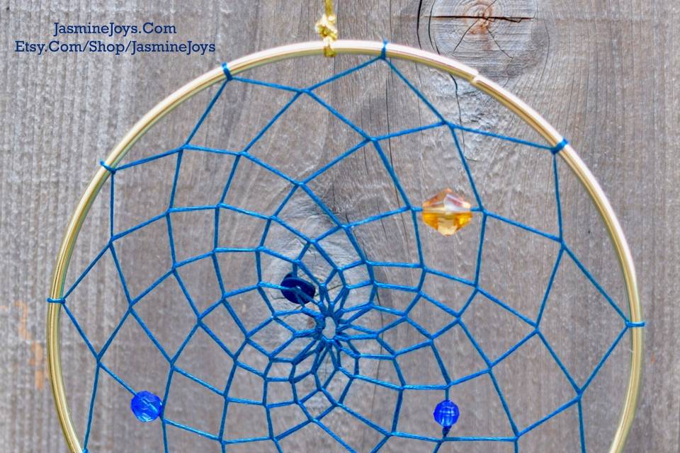 This was made for a couple wanted to incorporate geodes into a modern take on the dream catcher, in their wedding colors of navy blue and gold. They opted for several dream catchers to hang throughout their reception venue