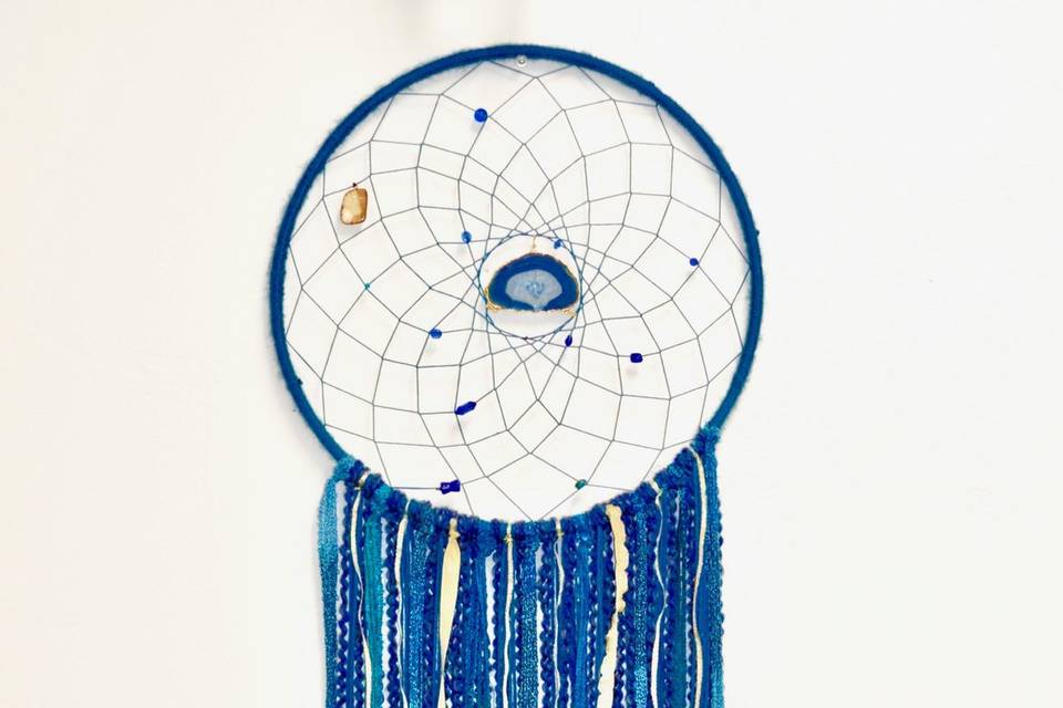This was made for a couple wanted to incorporate geodes into a modern take on the dream catcher, in their wedding colors of navy blue and gold. They opted for several dream catchers to hang throughout their reception venue