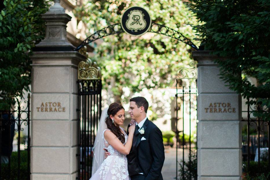 Couple pose in front of the gate
