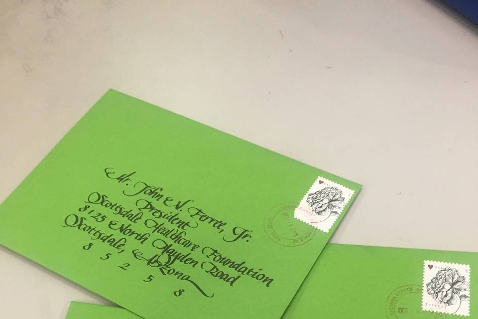 hand drawn calligraphy on envelopes with a fancy cursive lettering style