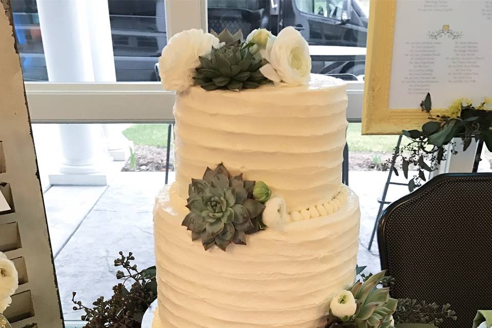 Rustic wedding set up at Manchester Country Club wedding event.  Simple, rustic cake with succulents and peonies.