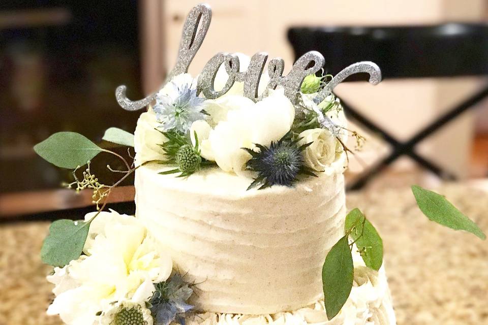 3 tier cake with rosette detail on middle tier, rustic texture and hand made 