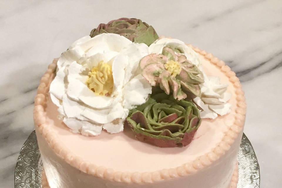 Bridal shower cake with hand piped swiss meringue buttercream flowers and succulents.