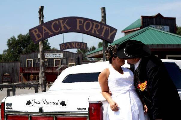 Newlyweds by the limo