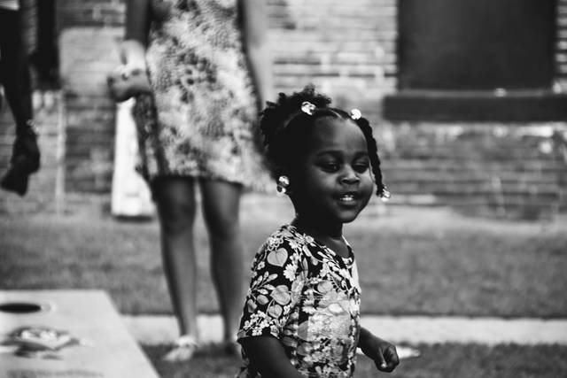 A young wedding guest enjoying lawn games.