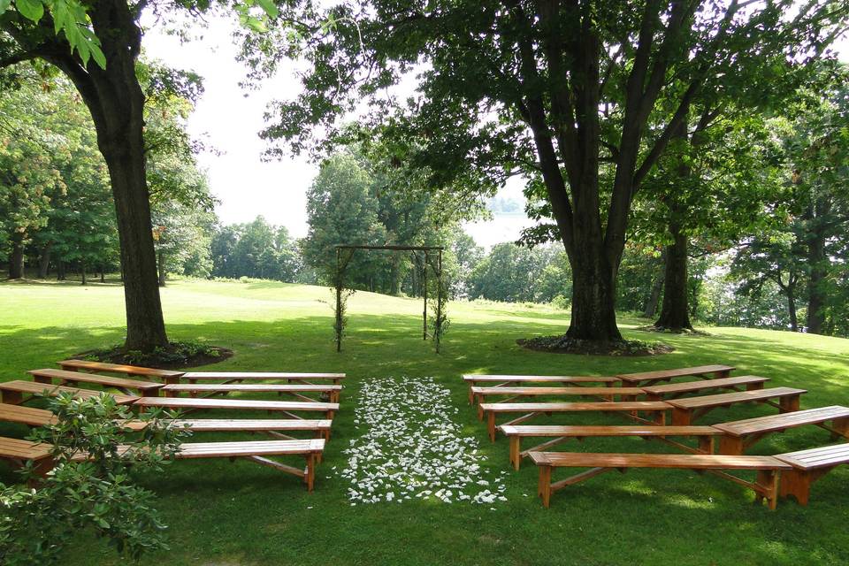 Natural wood benches in a ceremony setting