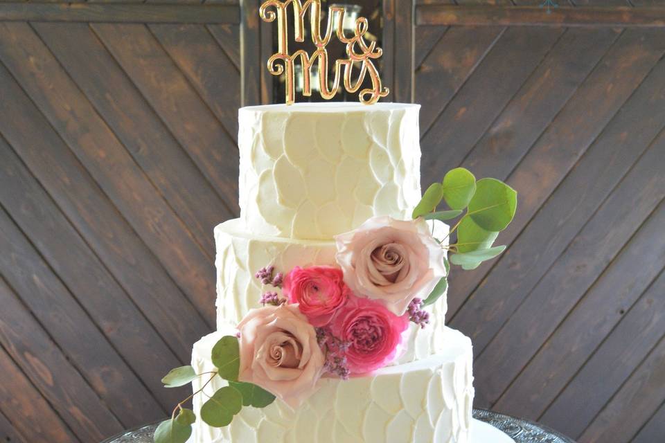 Rustic 3 tier buttercream cake with beautiful fresh flowers.