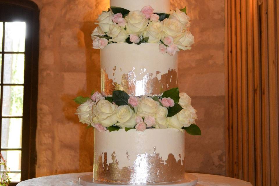 4 tier all buttercream cake with beautiful silver leaf finishes and fresh flowers.