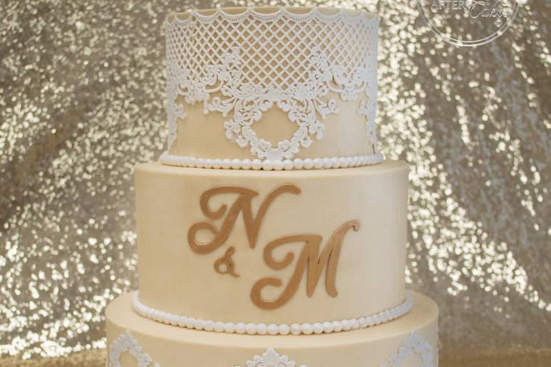 Lace and gold monogram wedding cake.