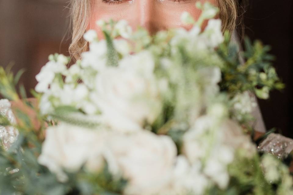 Bride looking over her flowers