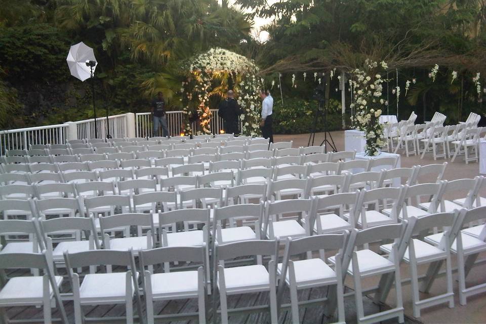 Ceremony setup outside with white chairs