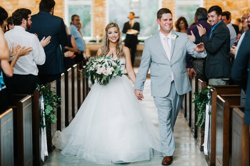 The couple walking in the isle