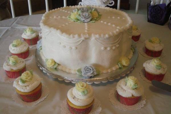 Mom's 80th birthday cake.  Lemon and marble layers with white roses and fondant bow on top, brushed with white petal dust.