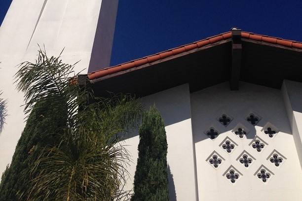 Front of church & steeple. Mission-style architecture.