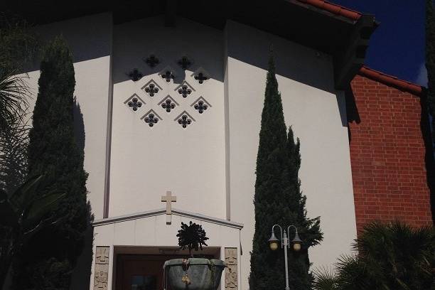 Front entrance to the church with succulent fountain in front of double doors.