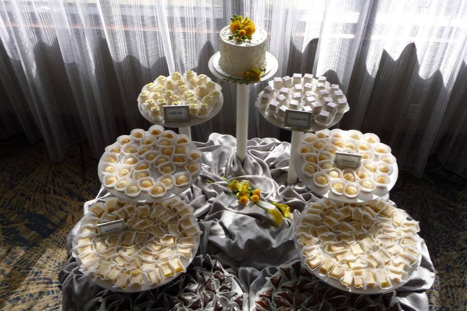 lemon bars, petit fours, macaroons, and a cake topper