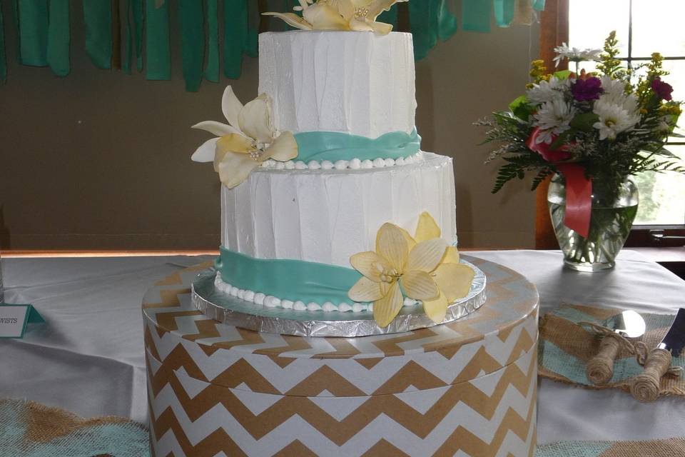 100% buttercream iced with a blue fondant ribbon