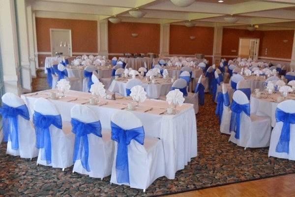 White chair covers with Blue organza bows. Head table.