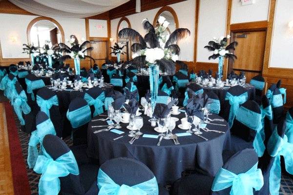 Black chair covers with Tiffany Blue organza bows.