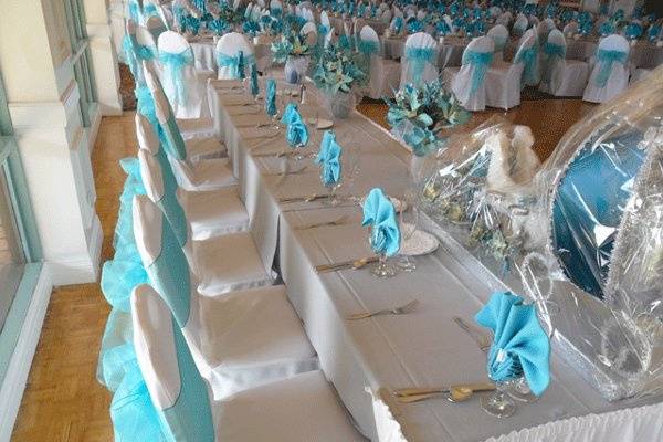 White chair covers with Tiffany Blue organza bows. Head table.