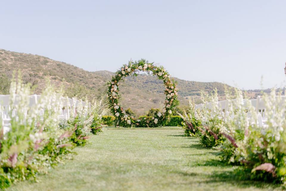 Floral aisle decor and circle arch