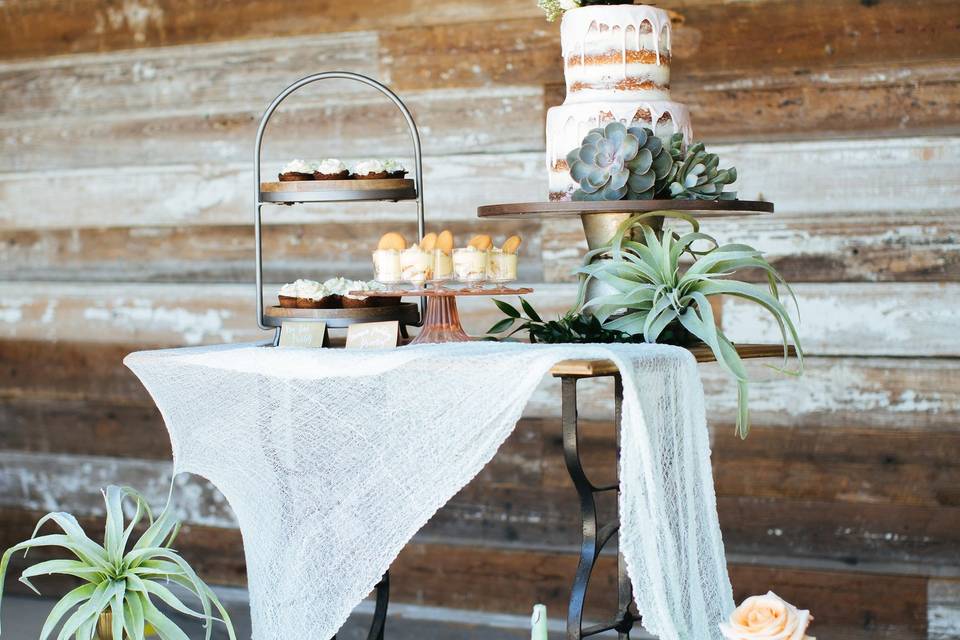 Vestige sewing tables, brass, handcrafted concrete vessels and a wide variety of dessert displays for a truly personalized dessert table