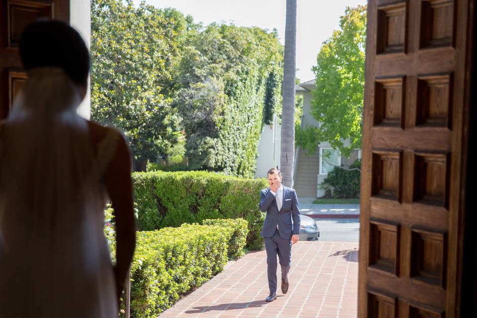 Groom seeing his bride in her wedding dress