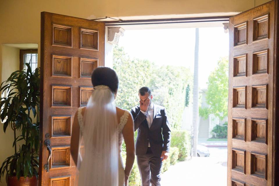Groom seeing his bride in her wedding dress