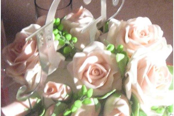 Gumpaste roses surround monogram topper.