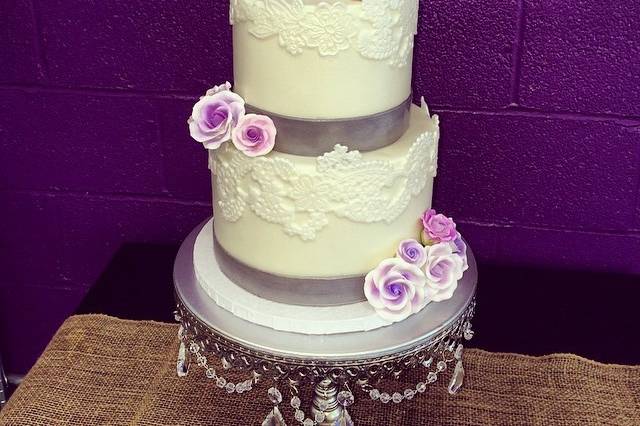 White wedding  cake with purple flowers