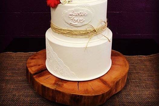 White wedding cake with a red flower
