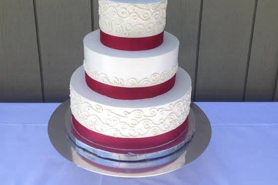 Wedding cake with red ribbon