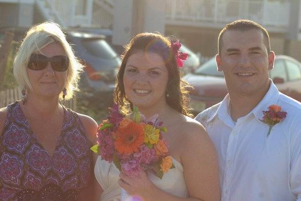 Bride on the way to the wedding! Stunning bouquet of vibrant summer flowers - roses, lilies, gerbera, orchids.